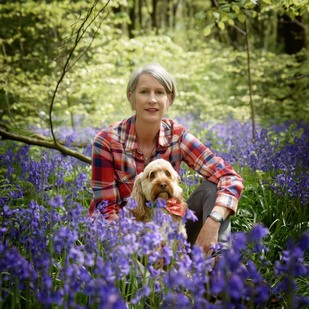 Natalie sat in the woods with her dog